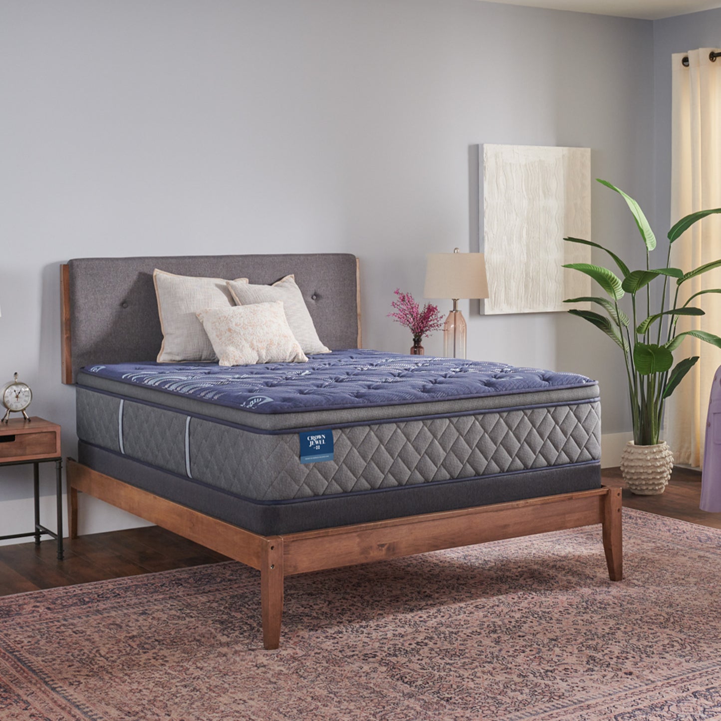 Mattress on a wooden bed frame in a bedroom setting with decor elements.
