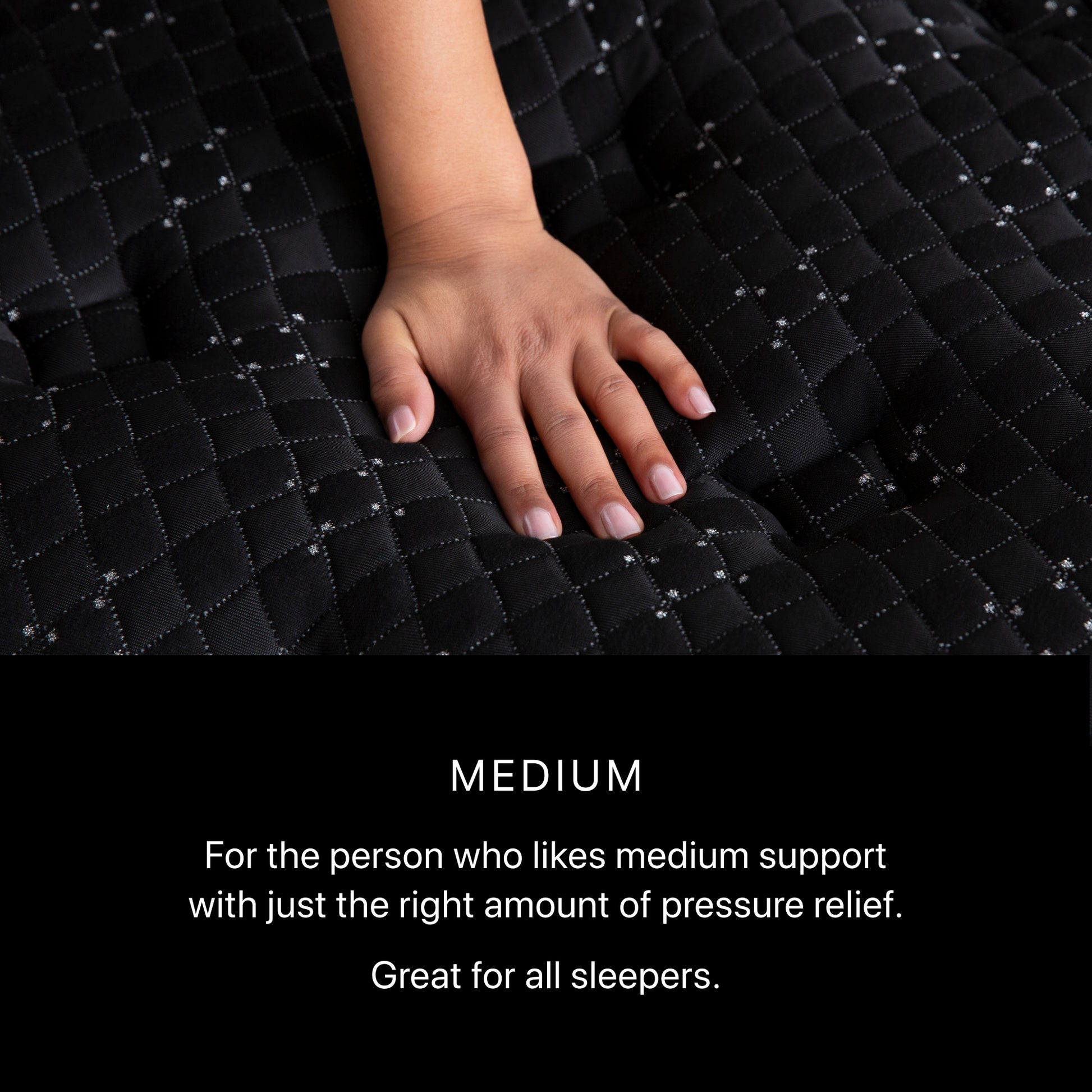 Hand on a black quilted mattress topper with text describing its firmness.